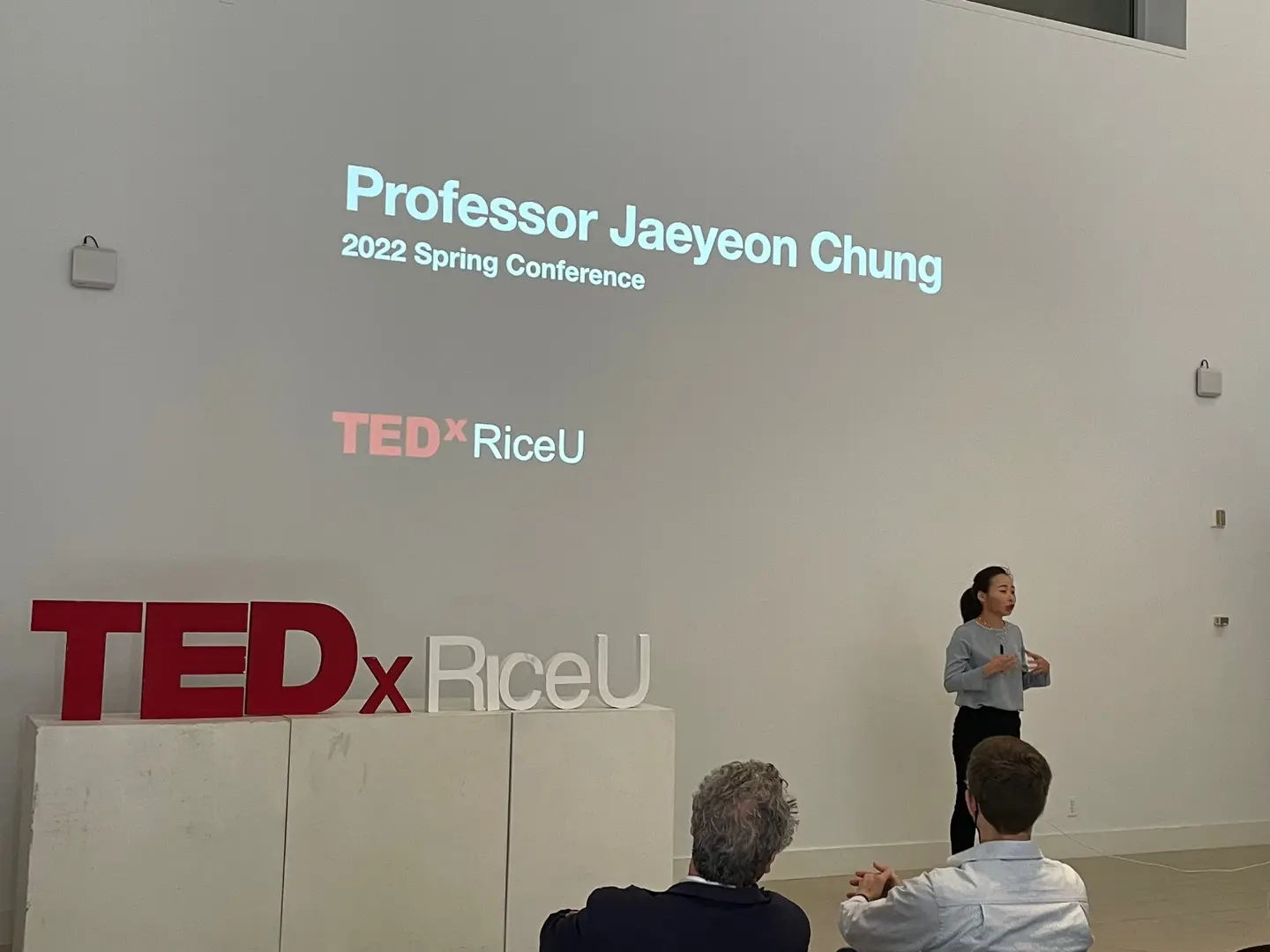 Jaeyeon Chung speaking onstage at TEDxRiceU